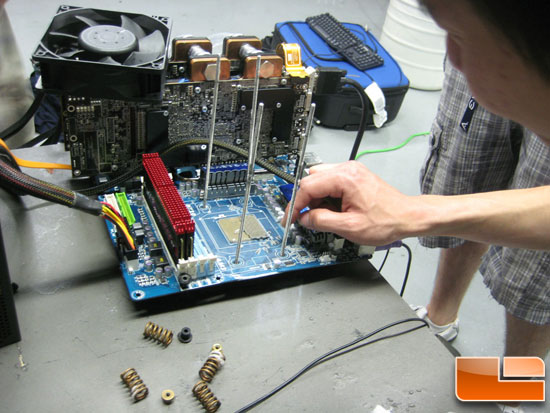 Gigabyte 790FXT-UD5P with Shamino examining the destroyed socket